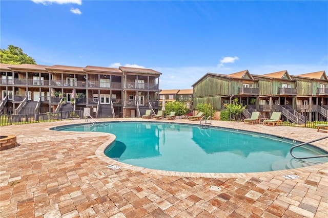311 Magnolia Ave Unit 54, Satsuma, AL 36572 - community pool with stairway, a patio, and a residential view