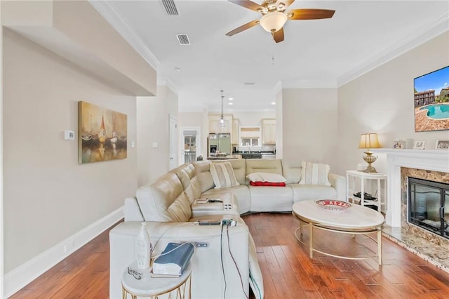 311 Magnolia Ave Unit 54, Satsuma, AL 36572 - living room with a ceiling fan, hardwood / wood-style floors, ornamental molding, a fireplace, and baseboards