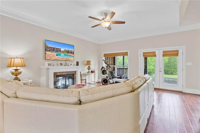 311 Magnolia Ave Unit 54, Satsuma, AL 36572 - living room featuring a ceiling fan, hardwood / wood-style floors, ornamental molding, a fireplace, and baseboards