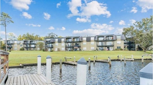 dock area with a water view and a yard