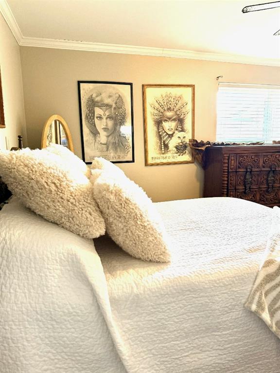 bedroom with crown molding