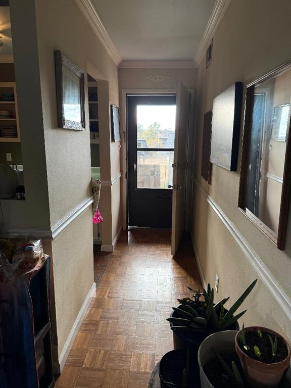 hall featuring ornamental molding and dark parquet floors