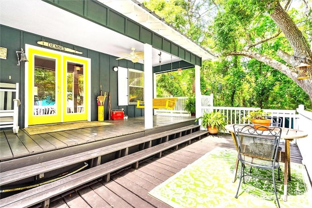 wooden terrace featuring french doors and ceiling fan