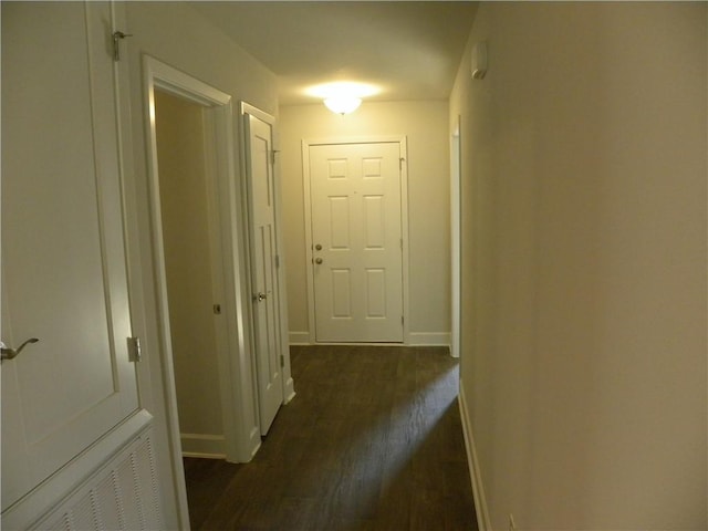 hallway with dark hardwood / wood-style flooring