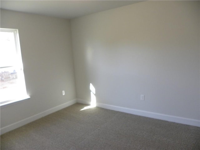 carpeted empty room with plenty of natural light