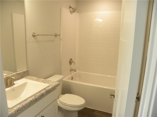 full bathroom featuring hardwood / wood-style flooring, vanity, toilet, and bathing tub / shower combination