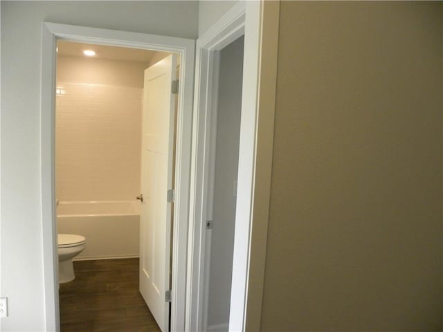 bathroom with hardwood / wood-style floors and toilet