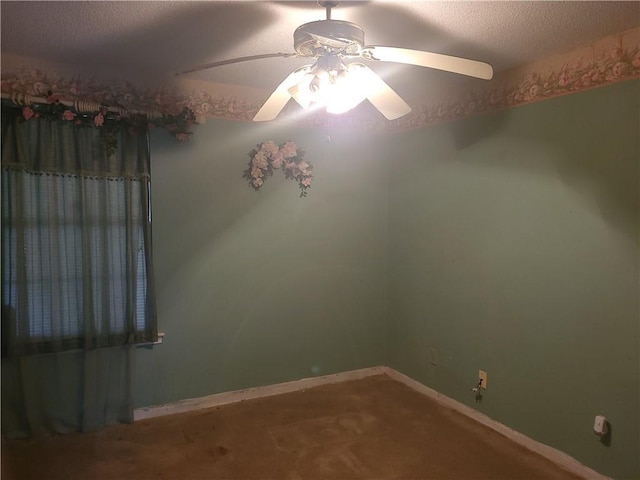 carpeted spare room featuring ceiling fan and a textured ceiling