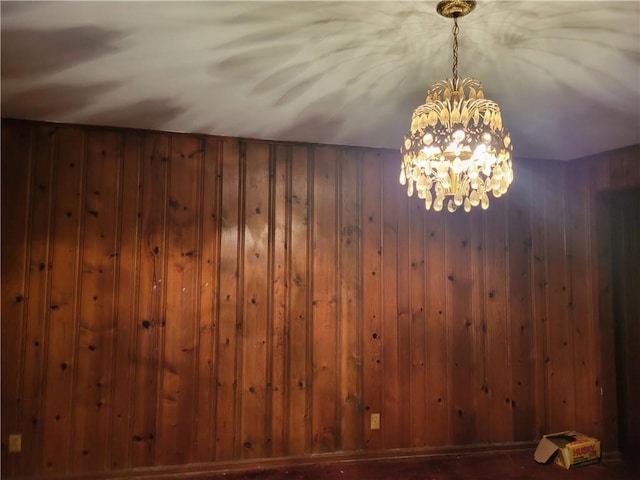 interior space featuring wood walls and an inviting chandelier