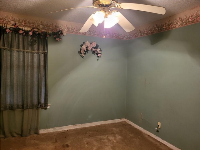 empty room featuring ceiling fan and a textured ceiling