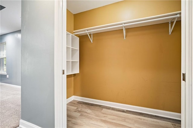 spacious closet featuring hardwood / wood-style flooring