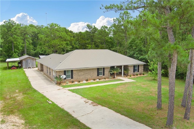 single story home featuring a front yard, driveway, a carport, and metal roof