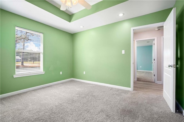 empty room with carpet flooring, ceiling fan, baseboards, and recessed lighting