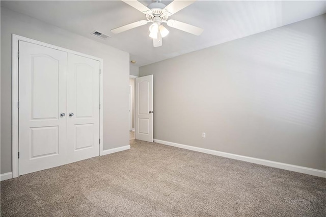 unfurnished bedroom featuring ceiling fan, a closet, and carpet