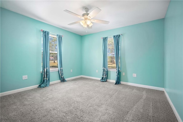spare room featuring carpet flooring, a ceiling fan, and baseboards