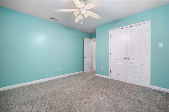 unfurnished bedroom featuring a closet, carpet flooring, baseboards, and ceiling fan