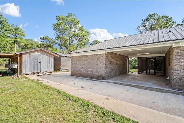 view of property exterior with a yard, a storage shed, and a carport