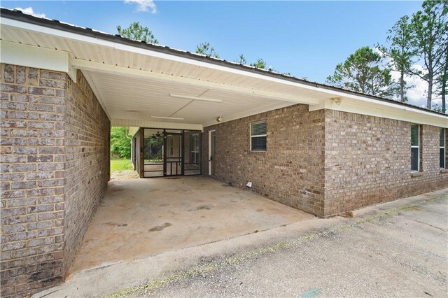 view of property exterior with brick siding and an attached carport