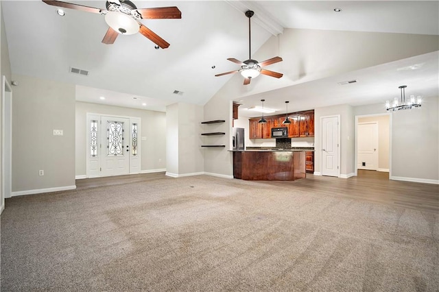 unfurnished living room featuring dark colored carpet, ceiling fan with notable chandelier, and vaulted ceiling with beams