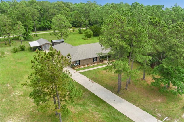 view of subject property with a heavily wooded area