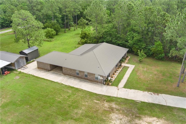 view of subject property with a heavily wooded area