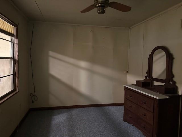 unfurnished bedroom with baseboards and ceiling fan