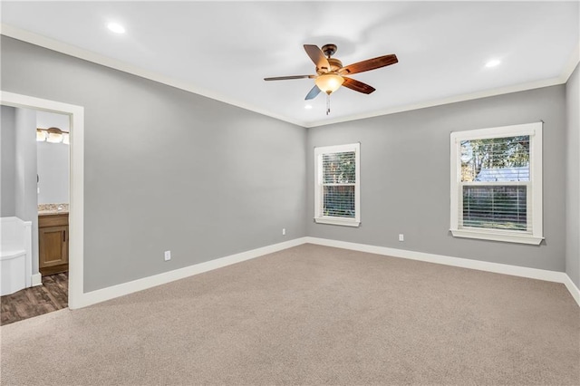 spare room featuring crown molding, carpet, a healthy amount of sunlight, and ceiling fan