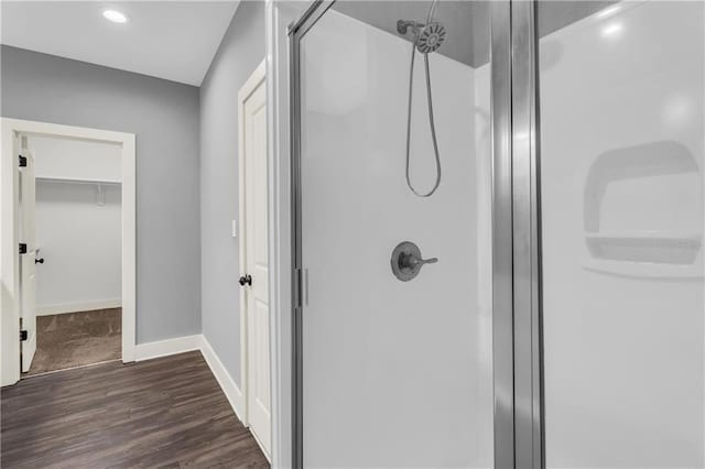 bathroom featuring hardwood / wood-style floors and a shower with shower door