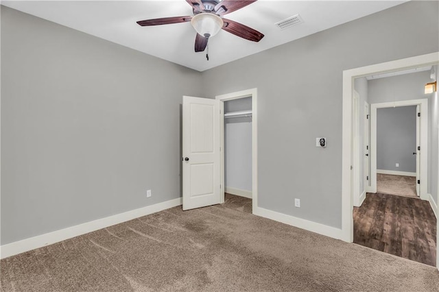 unfurnished bedroom with carpet floors, a closet, and ceiling fan