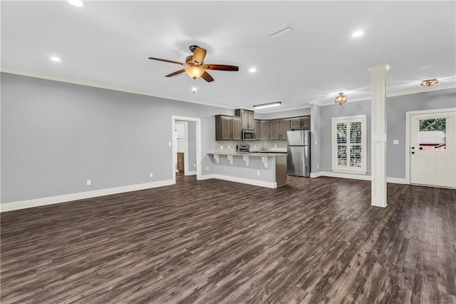 unfurnished living room featuring crown molding, ceiling fan, and dark hardwood / wood-style flooring