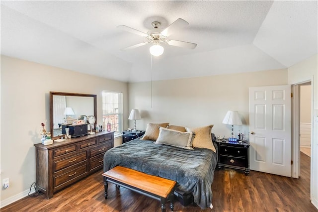 bedroom with lofted ceiling, ceiling fan, baseboards, and dark wood-style flooring