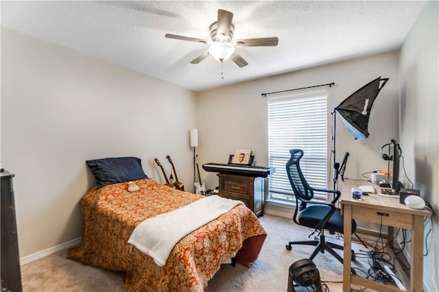 bedroom with a textured ceiling, carpet floors, a ceiling fan, and baseboards