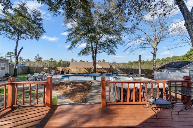 wooden deck featuring a fenced backyard and a fenced in pool