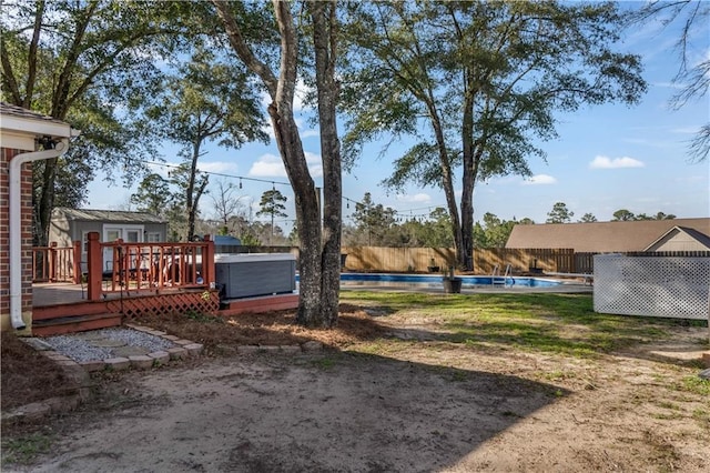 view of yard featuring a fenced backyard, a fenced in pool, and a wooden deck