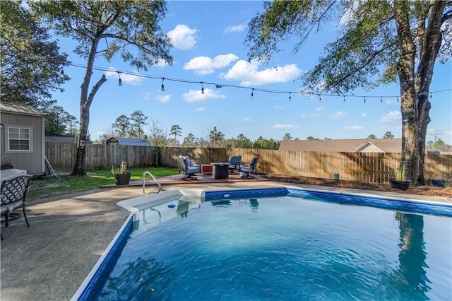 view of swimming pool featuring a patio area, a fenced backyard, and a fenced in pool