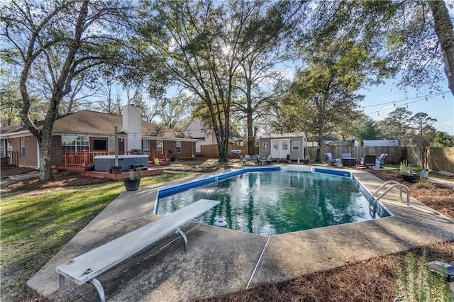 view of pool with a fenced in pool, a fenced backyard, an outbuilding, a storage unit, and a deck