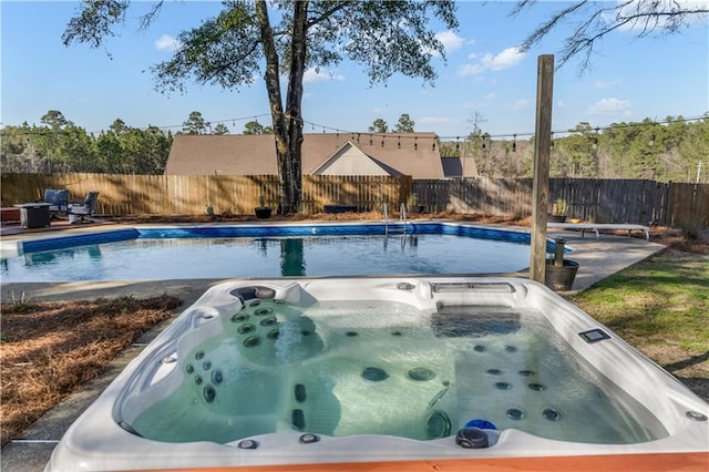 view of swimming pool featuring fence and a patio