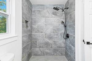 bathroom with a tile shower