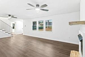 unfurnished living room with dark hardwood / wood-style floors