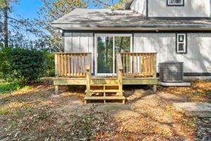 back of house featuring a deck and central air condition unit