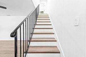 stairway with hardwood / wood-style flooring