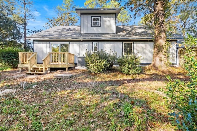 rear view of house featuring a wooden deck