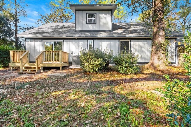 rear view of property featuring a deck