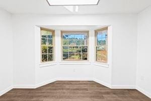 unfurnished dining area with dark wood-type flooring