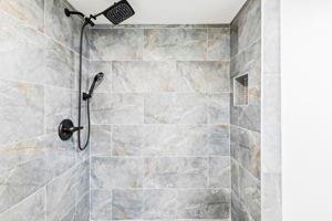 bathroom with tiled shower