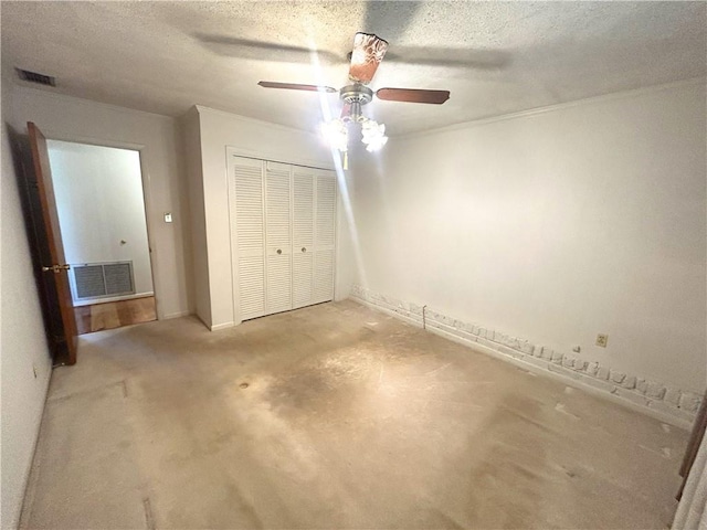 unfurnished bedroom with a ceiling fan, a textured ceiling, visible vents, and a closet