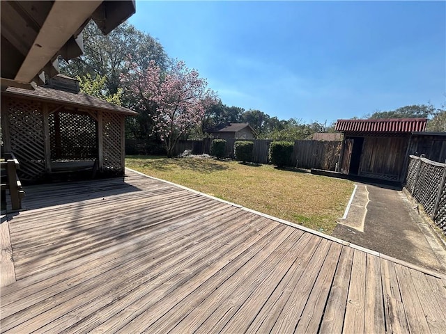 deck featuring a lawn and a fenced backyard