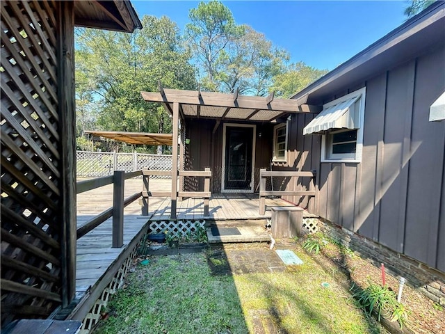 property entrance featuring a deck and board and batten siding