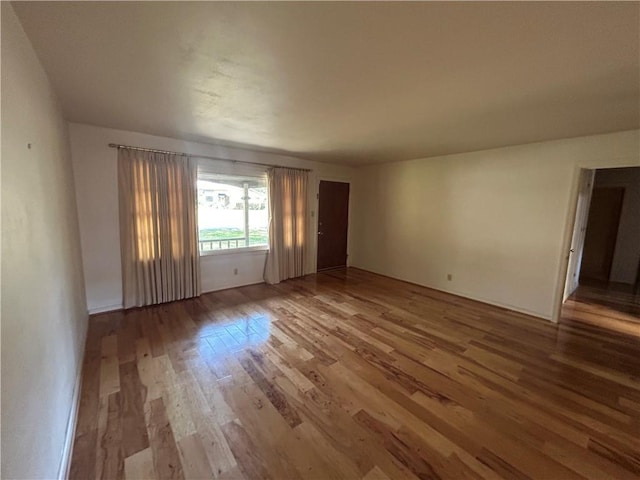 spare room with wood finished floors