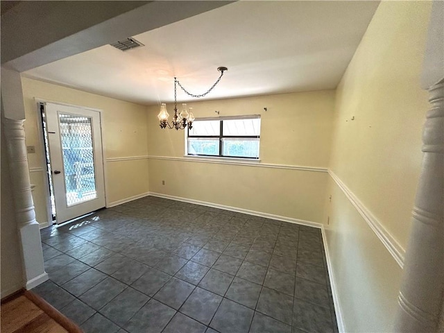 unfurnished dining area featuring baseboards, visible vents, and a notable chandelier